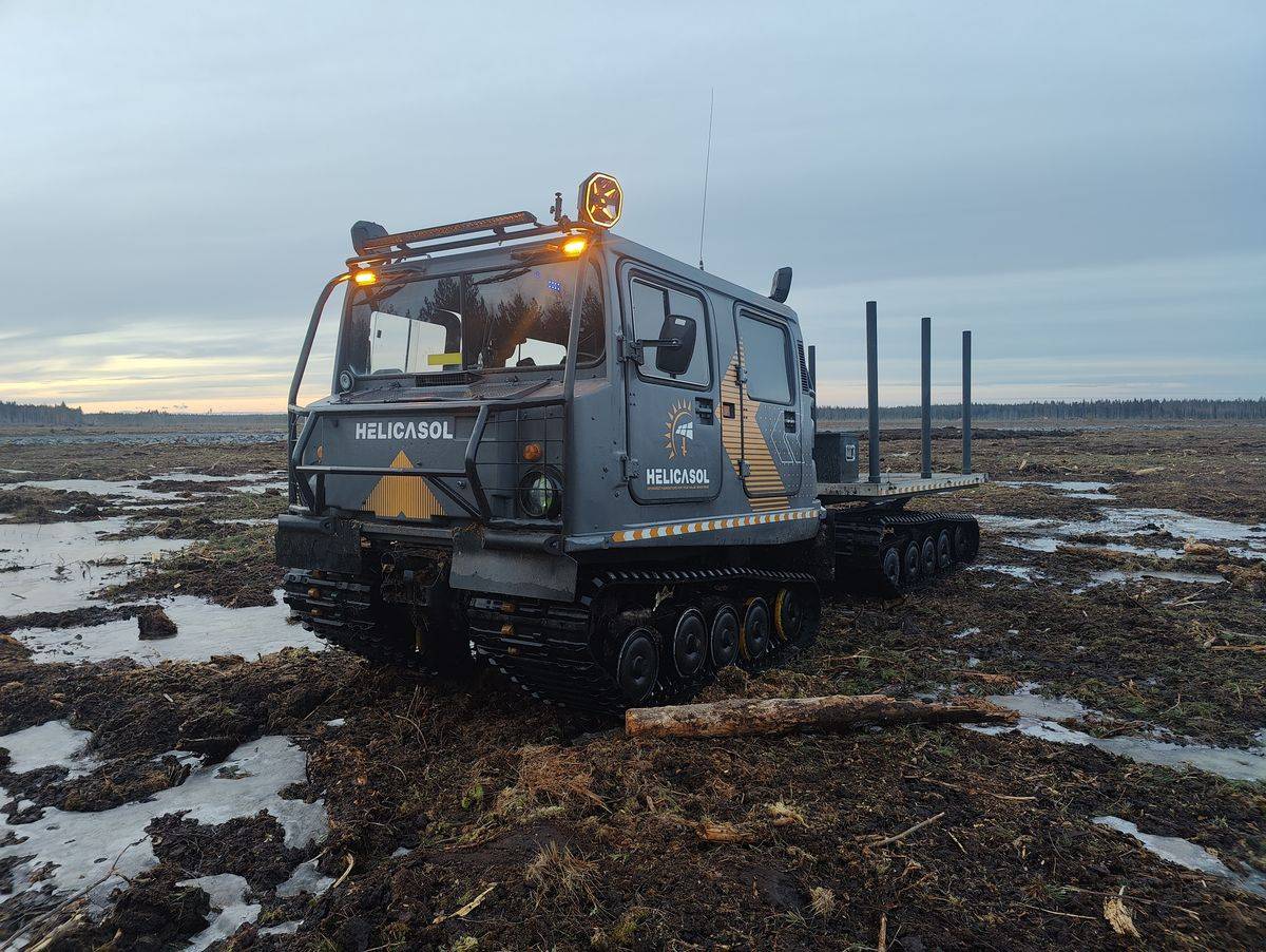 Helicasol-branded tracked Bandvagn carrier on peat ground